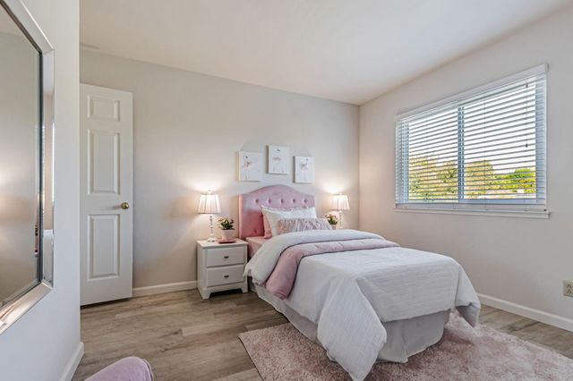 a bedroom with a bed and a window