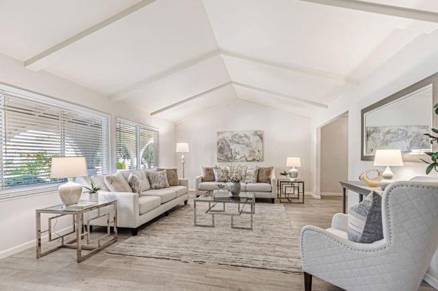 a living room with furniture or couch and a large window