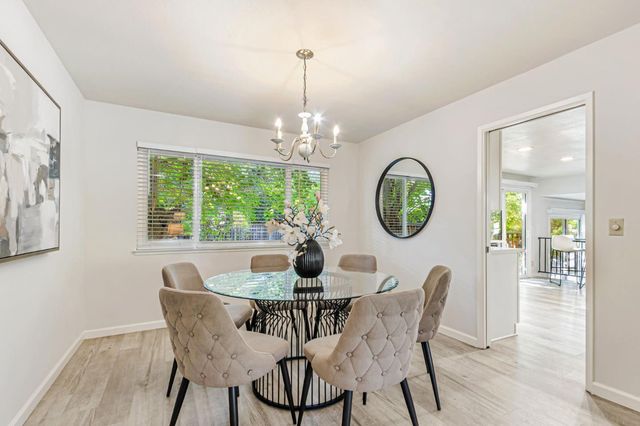 a dining room with furniture a mirror and a window