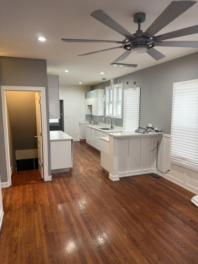 7806 South Rhodes Avenue Chicago, IL 60619 - Photo 11 of 29 a room with stainless steel appliances kitchen island hardwood floor and a window