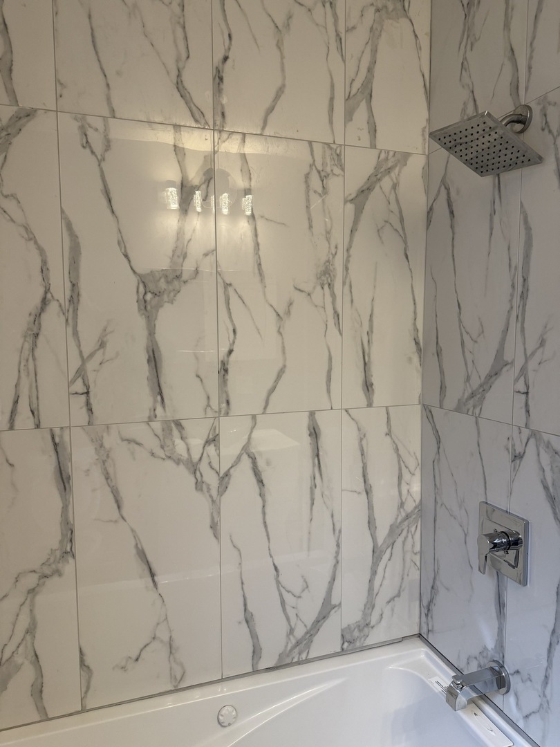 7806 South Rhodes Avenue Chicago, IL 60619 - Photo 14 of 29 a white bath tub sitting next to a shower