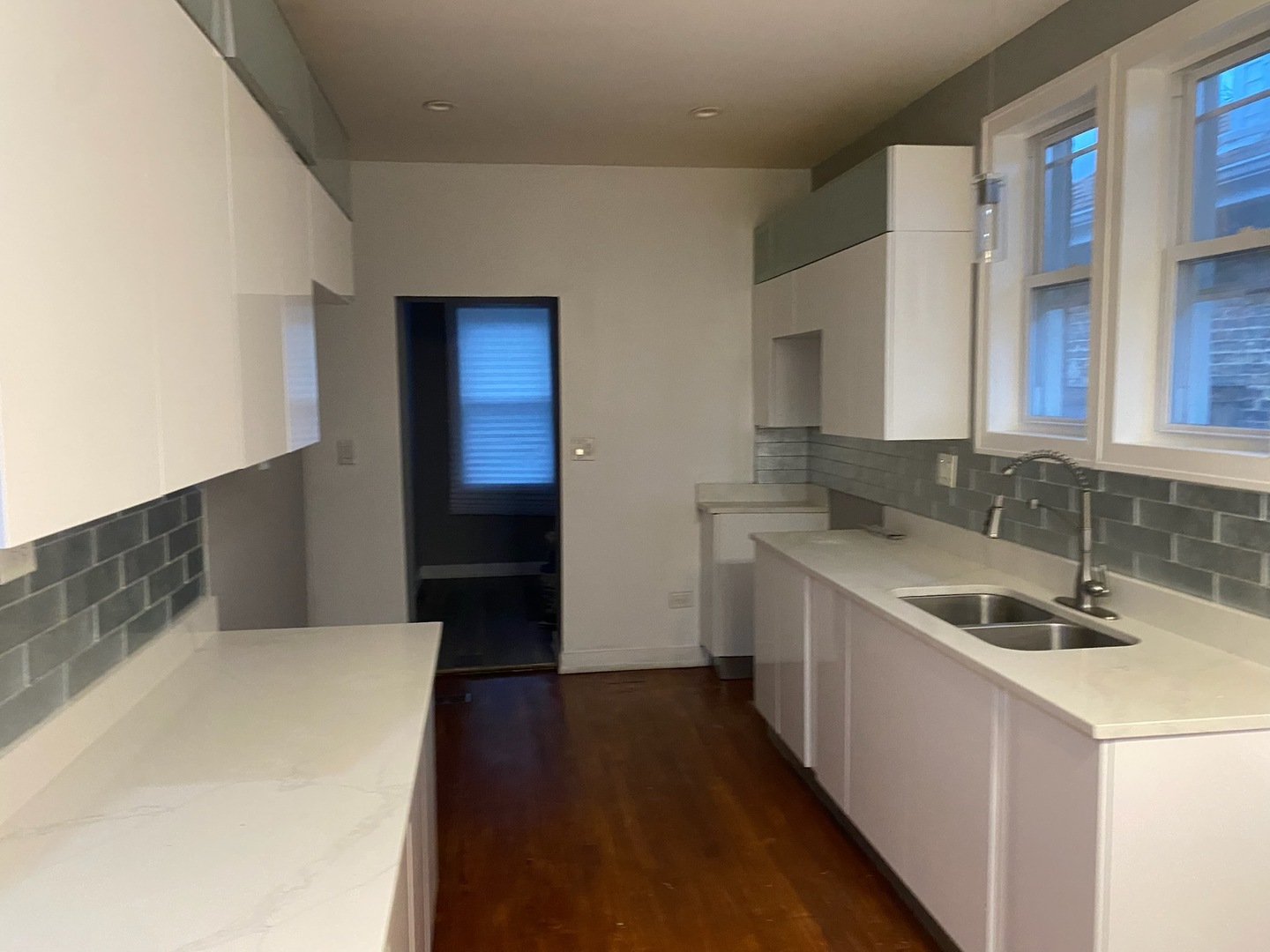 7806 South Rhodes Avenue Chicago, IL 60619 - Photo 21 of 29 a kitchen with a sink and wooden cabinets