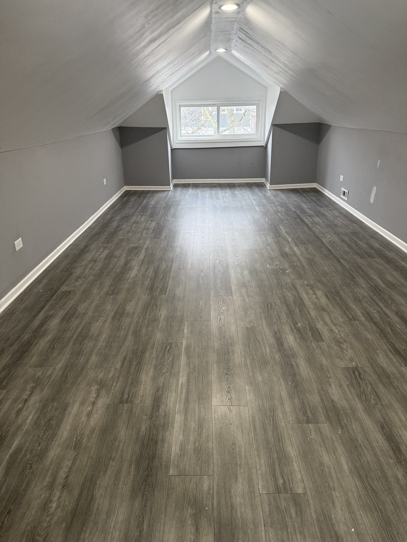 7806 South Rhodes Avenue Chicago, IL 60619 - Photo 24 of 29 an empty room with wooden floor and windows