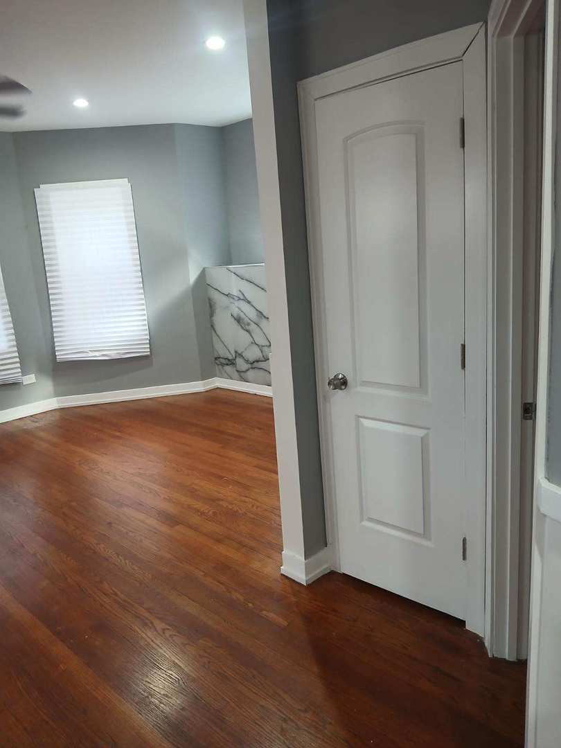 7806 South Rhodes Avenue Chicago, IL 60619 - Photo 26 of 29 a view of hallway with wooden floor