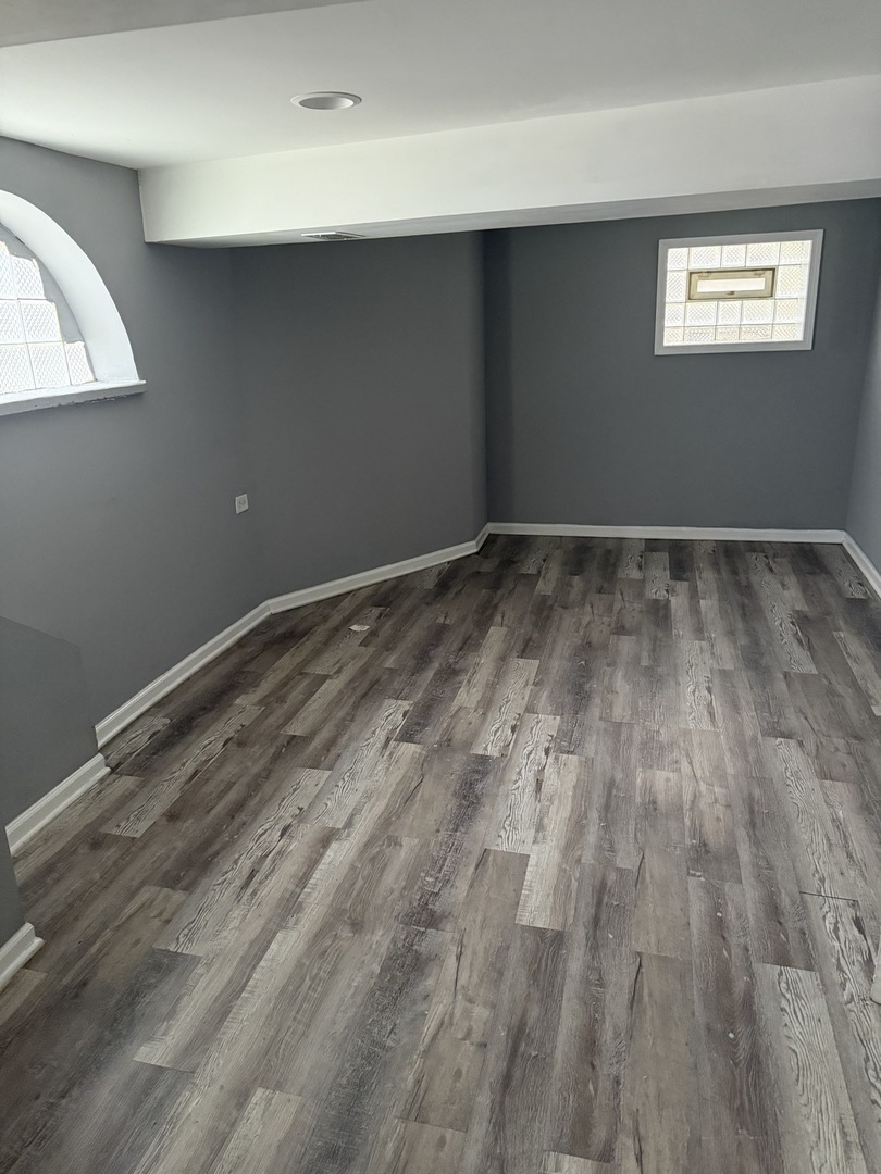 7806 South Rhodes Avenue Chicago, IL 60619 - Photo 27 of 29 a view of empty room with wooden floor