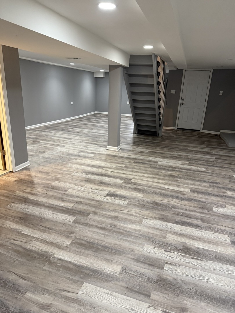 7806 South Rhodes Avenue Chicago, IL 60619 - Photo 29 of 29 an empty room with wooden floor and a ceiling fan