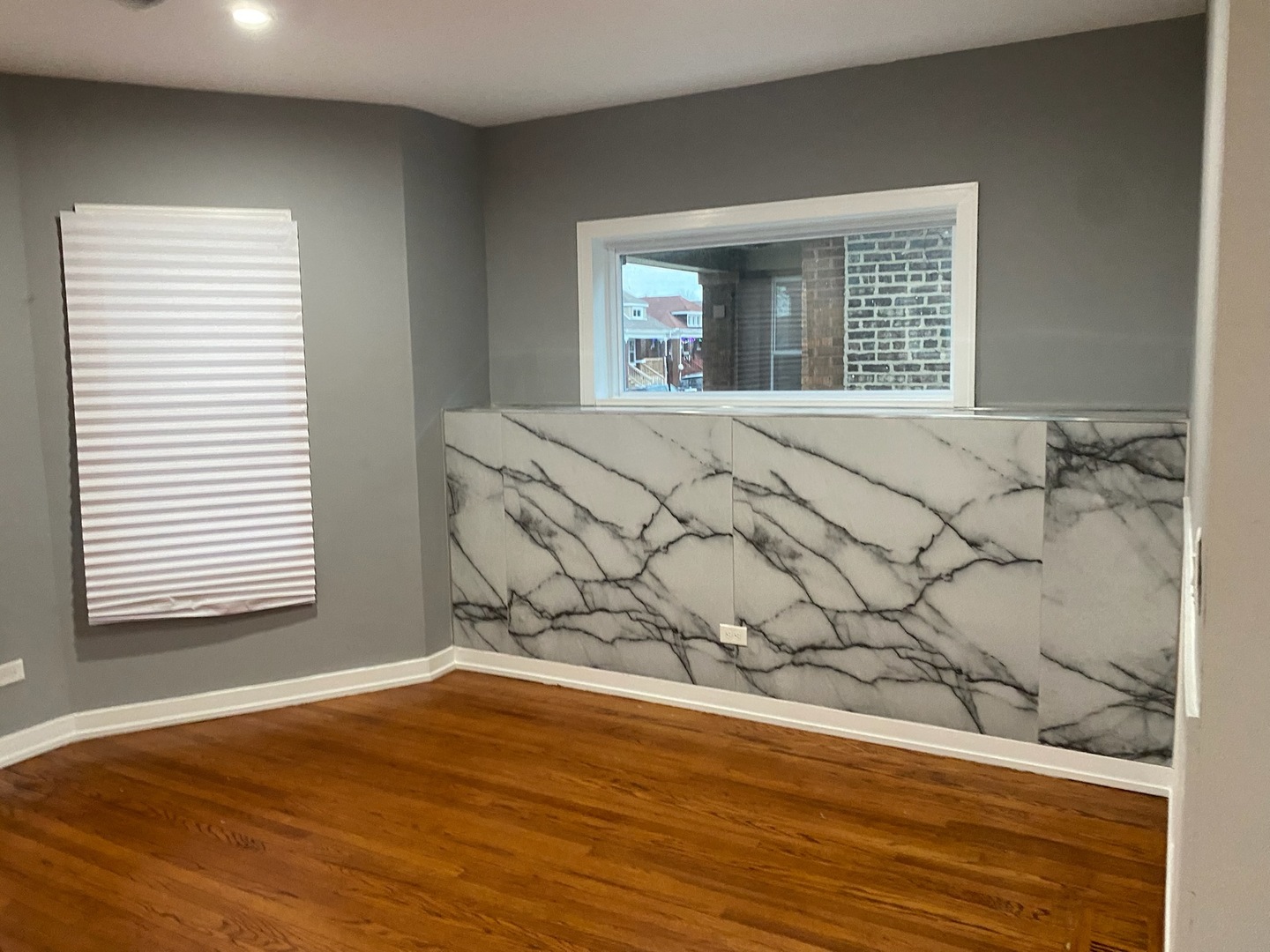 7806 South Rhodes Avenue Chicago, IL 60619 - Photo 7 of 29 a view of a bedroom with wooden floor and a window