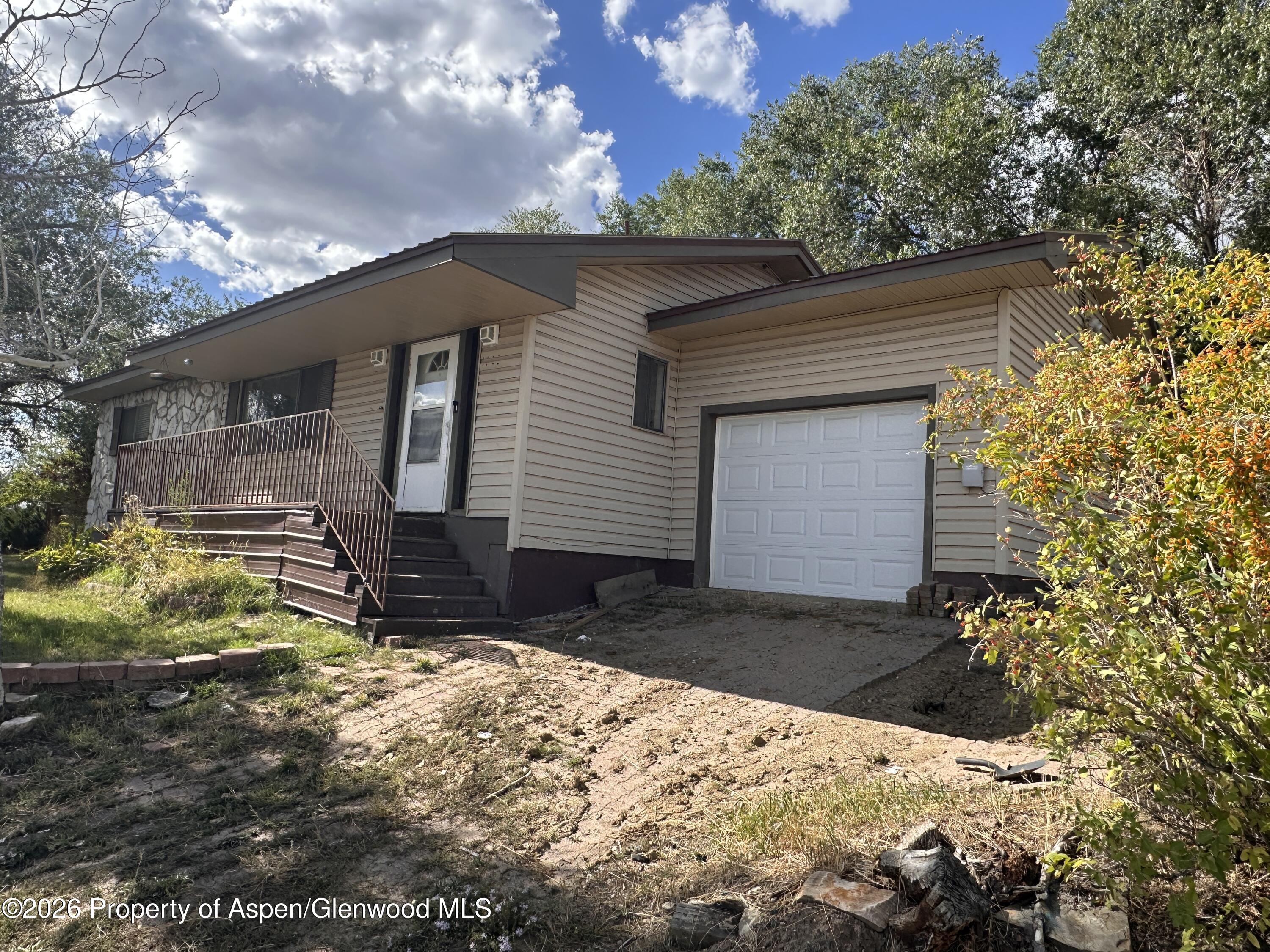 1903 Frontier Drive Craig, CO 81625 - Photo 2 of 16 a backyard of a house with yard and outdoor seating