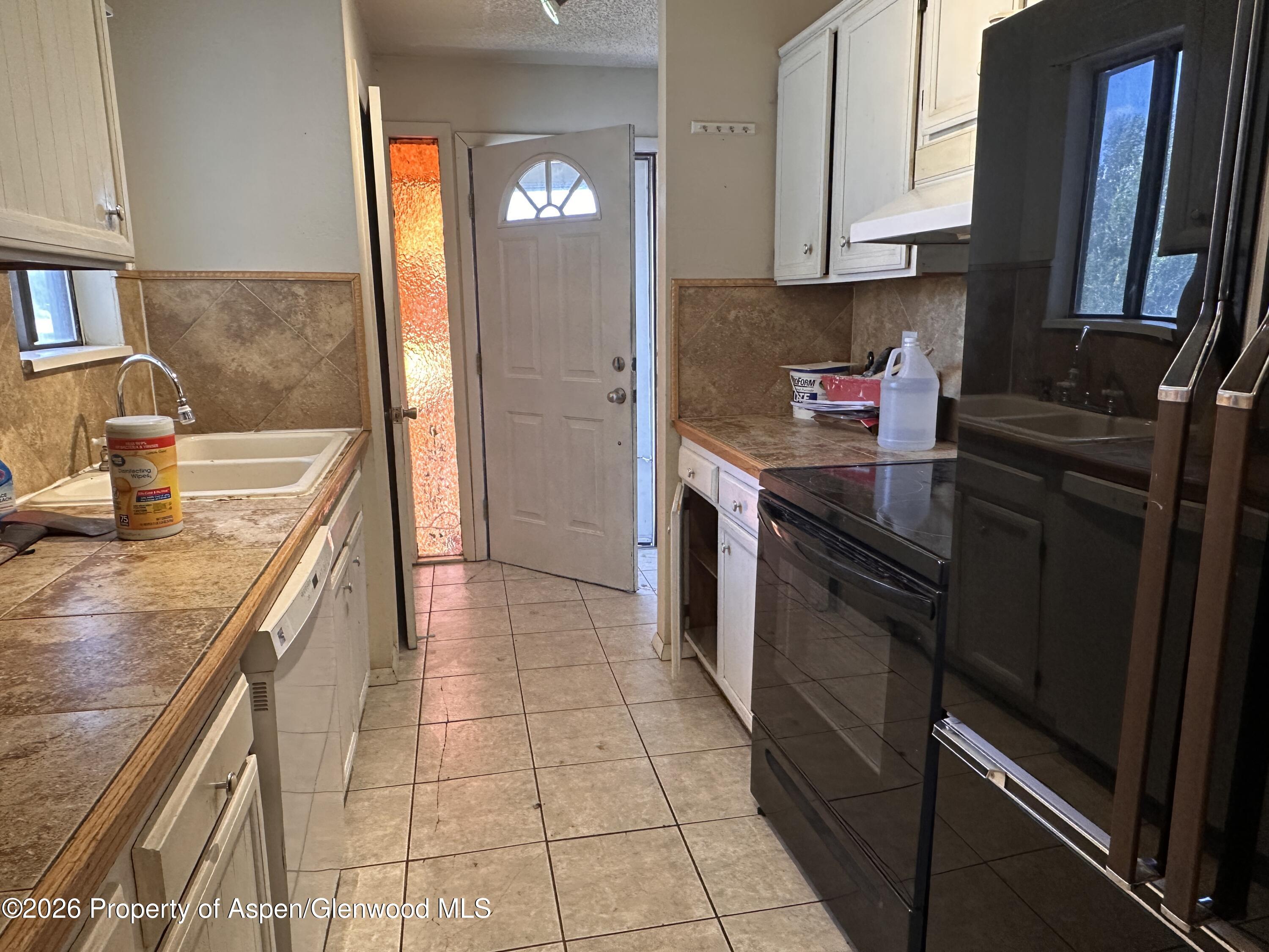 1903 Frontier Drive Craig, CO 81625 - Photo 5 of 16 a kitchen with stainless steel appliances granite countertop a sink stove and refrigerator
