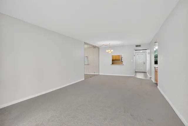 a view of an empty room and a window