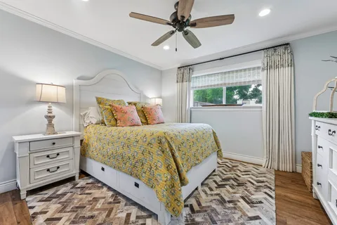 a bedroom with a bed a dresser and a window