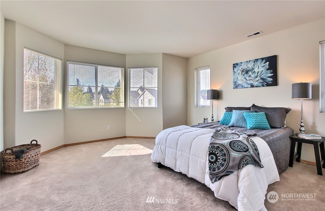 2280 Simmons Street, Unit A DuPont, WA 98327 - Photo 14 of 25 a bed sitting in a bedroom next to a window