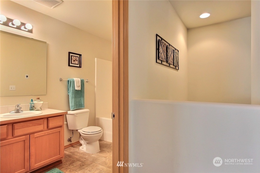 2280 Simmons Street, Unit A DuPont, WA 98327 - Photo 18 of 25 a bathroom with a sink a toilet and shower