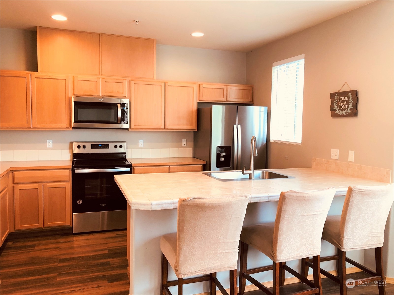 2280 Simmons Street, Unit A DuPont, WA 98327 - Photo 10 of 25 a kitchen with stainless steel appliances a refrigerator stove microwave and cabinets