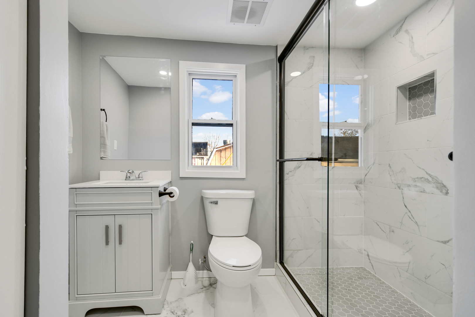 3813 Morgan Street Steger, IL 60475 - Photo 16 of 23 a bathroom with a toilet a sink and glass door