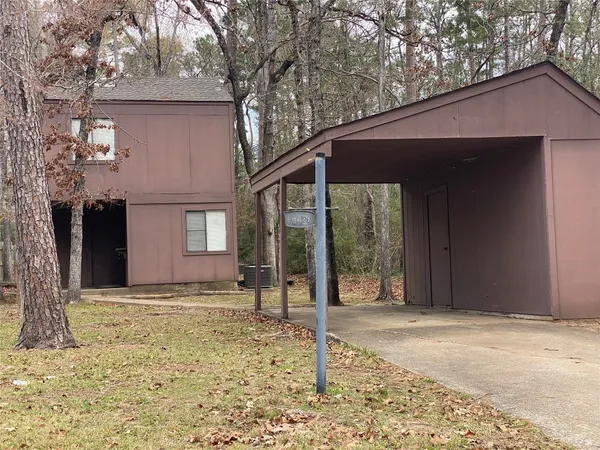 a house that has a tree in front of it