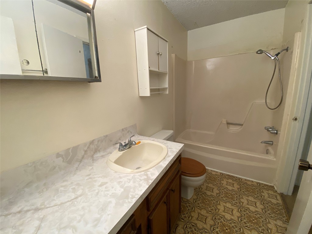 28628 Netawake Court Point Blank, TX 77364 - Photo 5 of 13 a bathroom with a granite countertop sink a toilet and shower