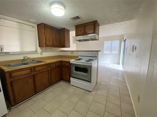 a kitchen with a stove sink and microwave