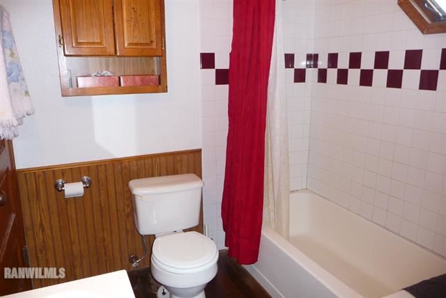 82 Bean Street Road Benton, WI 53803 - Photo 8 of 9 a white toilet sitting next to a bathroom sink and vanity