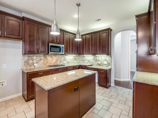 a bathroom with a granite countertop double vanity sink and mirror
