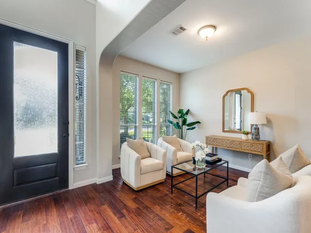 a living room with furniture and wooden floor