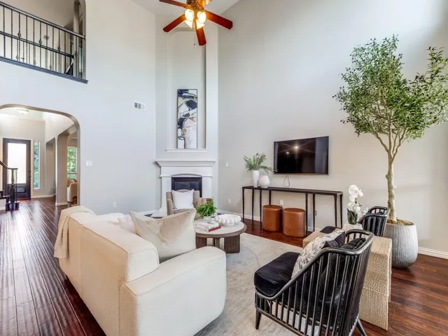 a living room with furniture a fireplace and a flat screen tv