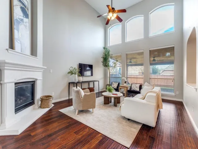 a living room with furniture a fireplace and a table