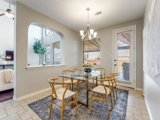 a view of a dining room with furniture and chandelier