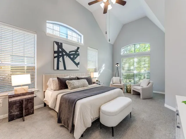 a bedroom with a bed couch and window