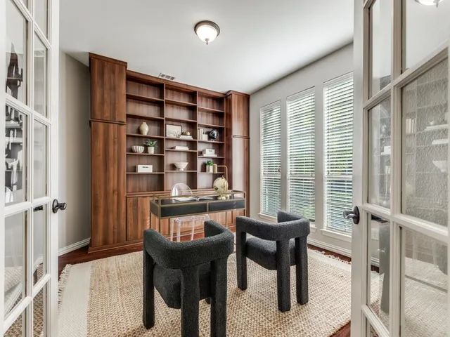 a living room with furniture a large window and a flat screen tv