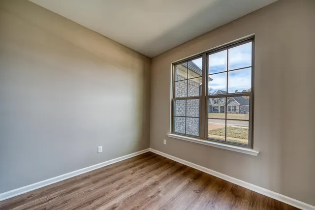 a large kitchen with stainless steel appliances kitchen island granite countertop a large cabinets a sink and a stove