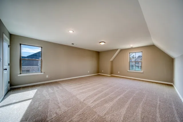 an empty room with window and pillar in it