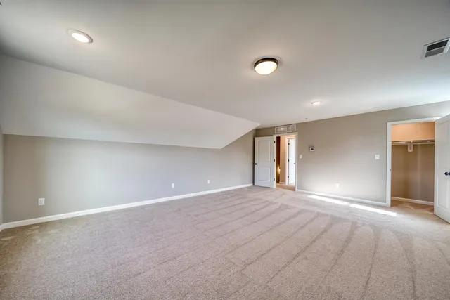 an empty room with windows and closet