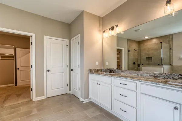 a bathroom with a granite countertop sink mirror and