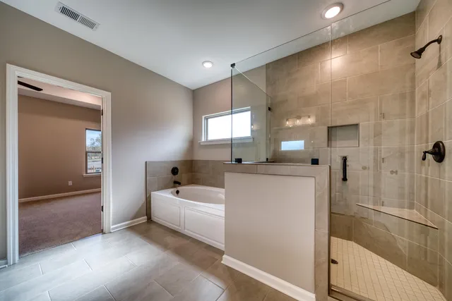 a room with a bed a flat screen tv and a couch