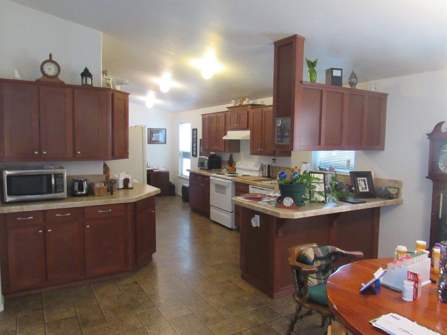 1961 Crow Road Merlin, OR 97532 - Photo 30 of 35 a kitchen with stainless steel appliances kitchen island granite countertop a sink and cabinets