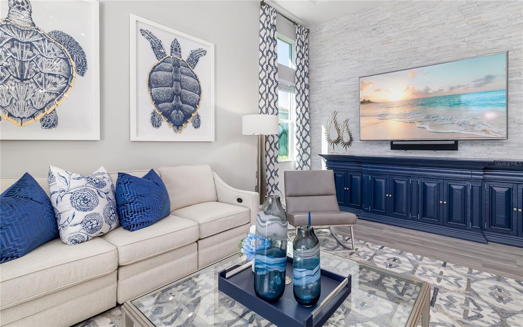 8362 Redonda Loop Bradenton, FL 34202 - Photo 11 of 58 a living room with furniture and a flat screen tv