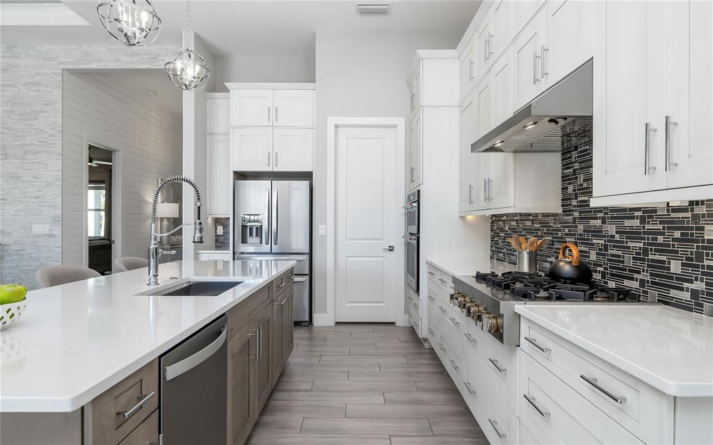 8362 Redonda Loop Bradenton, FL 34202 - Photo 13 of 58 a kitchen with stainless steel appliances a sink stove and refrigerator