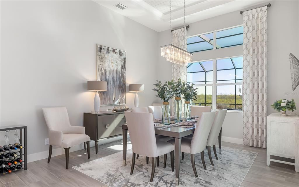 8362 Redonda Loop Bradenton, FL 34202 - Photo 16 of 58 a dining room with furniture potted plants and wooden floor