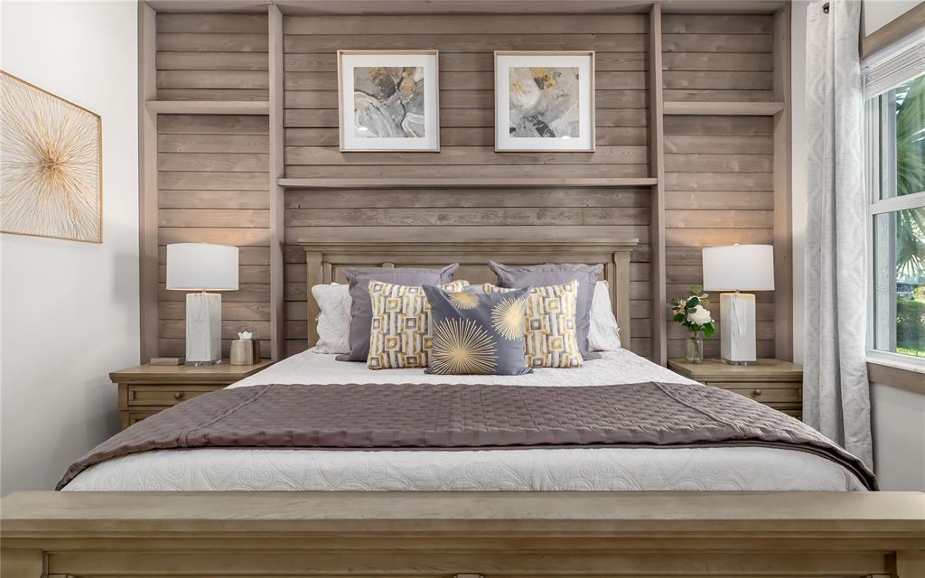 8362 Redonda Loop Bradenton, FL 34202 - Photo 24 of 58 a large bedroom with a bed and wooden floor