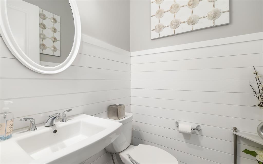 8362 Redonda Loop Bradenton, FL 34202 - Photo 31 of 58 a bathroom with a toilet sink and mirror