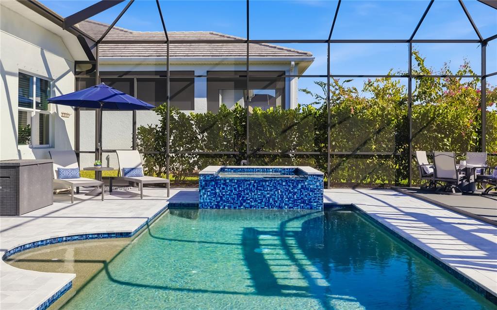 8362 Redonda Loop Bradenton, FL 34202 - Photo 8 of 58 a view of a chairs and table under an umbrella