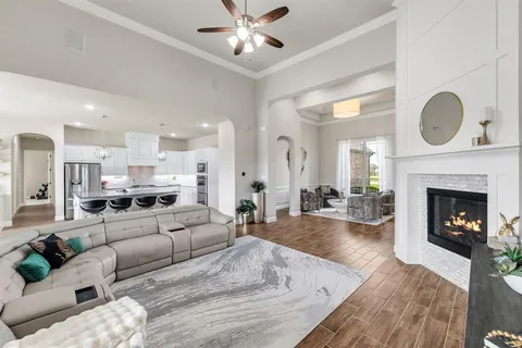a living room with furniture a fireplace and a large window