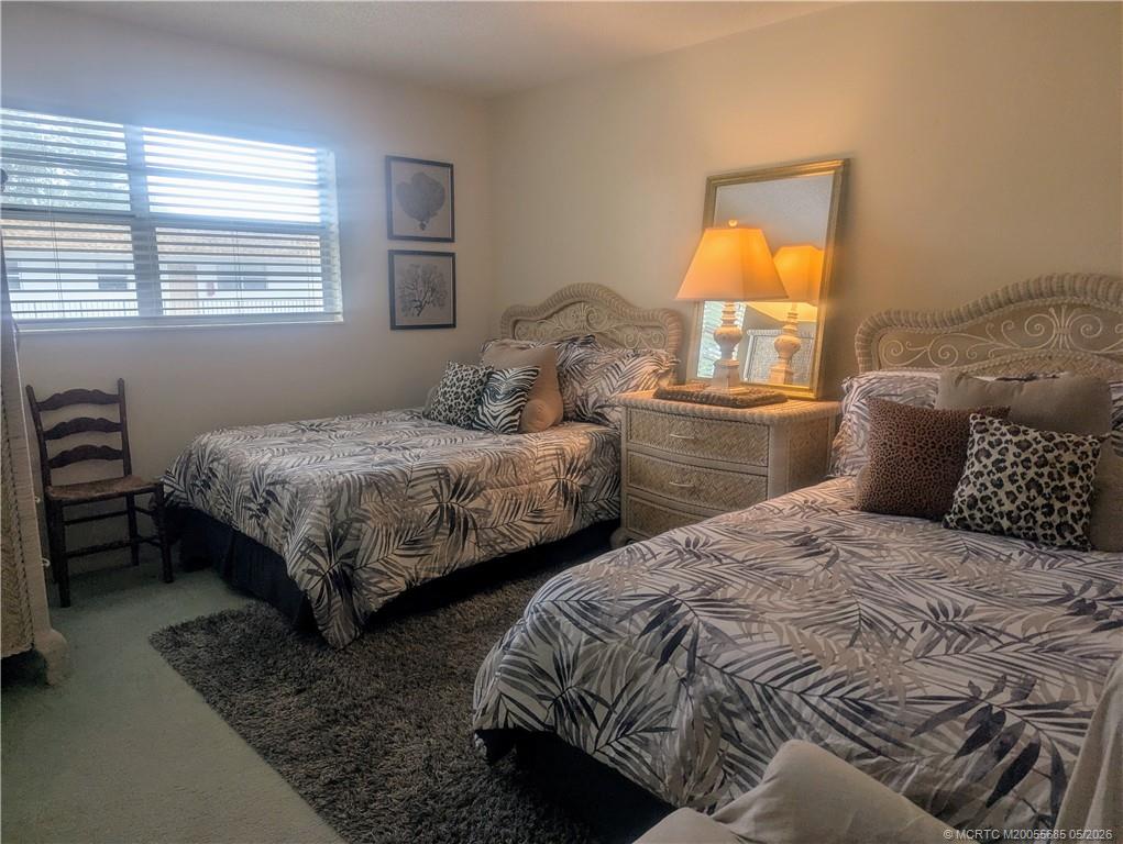 2950 Southeast Ocean Boulevard, Unit 56 Stuart, FL 34996 - Photo 10 of 12 a bedroom with two beds and a window