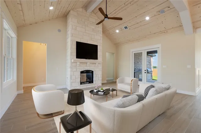 a living room with furniture a fireplace and a flat screen tv