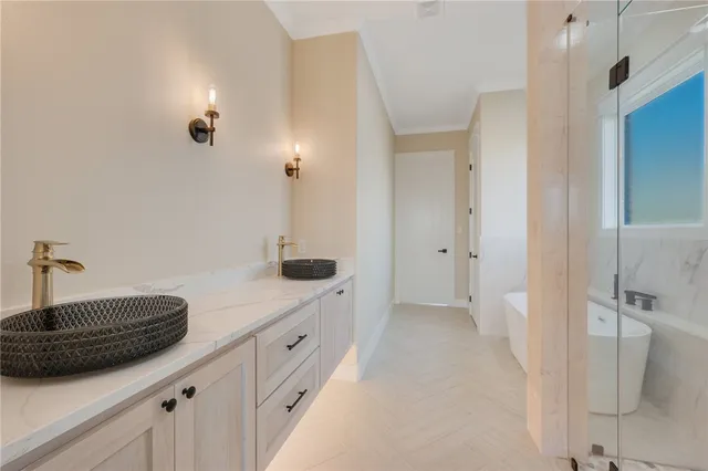 a bathroom with double sink and shower