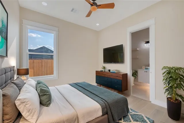 a bedroom with a bed and a flat screen tv