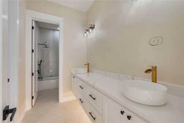 a bathroom with a double vanity sink and a mirror