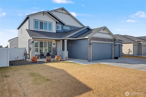 a front view of a house with patio and a yard