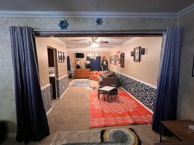 a kitchen with stainless steel appliances kitchen island granite countertop dining table chair and a refrigerator